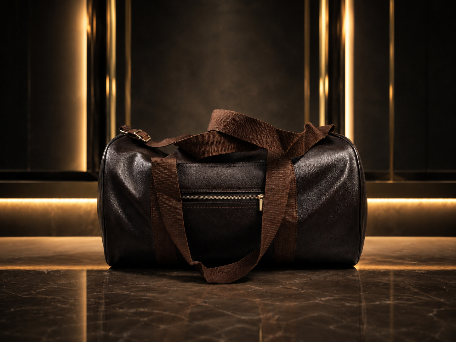 A dark brown leather duffel bag with matching brown webbing straps, displayed on a polished marble surface against a dark background with vertical gold light strips.