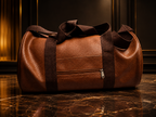 A brown pebbled leather duffel bag with dark brown webbing handles and a front zippered pocket, displayed on a polished dark marble surface against a dark wood-paneled background.